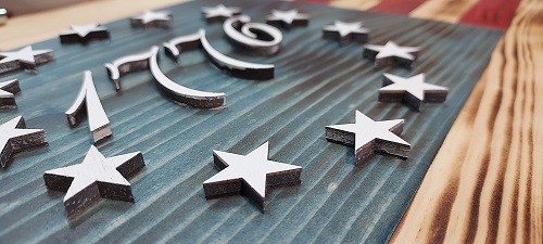 Laser cut stars and year, adding depth and character to the field.